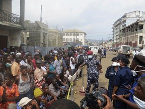 Family of victims of heavy flooding and mudslides in Regent wait to identify their bodies at Connaught hospital morgue in Sierra Leone, Freetown, Wednesday, Aug. 16 , 2017. Family members lined up in the pouring rain to identify their loved ones' remains following mudslides and floods in the capital that killed more than 300 people. The death toll is expected to rise as search efforts continue, and the risk of further mudslides remains. (AP Photo/ Manika Kamara)