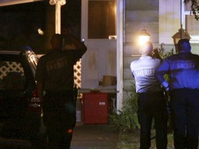 Ocean County Sheriff's Department officers investigate the scene of a homicide  in Lacey Township, N.J. on  Wednesday, Aug. 16, 2017.  A man is believed to have killed his wife, their 7-year-old son and the family dog in their home before killing himself, authorities said Thursday, Aug. 17. The Ocean County prosecutor's office said a 48-year-old woman, the child and the dog were found dead Wednesday afternoon in their Lacey Township home. A 51-year-old man died at a hospital of self-inflicted wounds, prosecutors said. (Thomas P. Costello/The Asbury Park Press via AP)