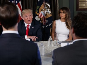First lady Melania Trump listens as President Donald Trump speaks during a briefing on the opioid crisis, Tuesday, Aug. 8, 2017, at Trump National Golf Club in Bedminster, N.J. (AP Photo/Evan Vucci)