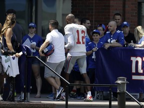 Spectators look on as New York Giants wide receiver Tavarres King (12) leaves the field early after limping off a play during NFL football training camp, Thursday, Aug. 3, 2017, in East Rutherford, N.J. (AP Photo/Julio Cortez)