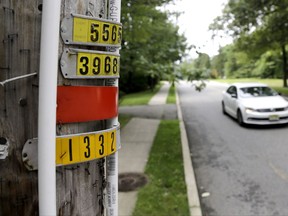 In this Saturday, Aug. 5, 2017, photo, polyvinyl chloride piping is seen on an utility pole as a vehicle drives by on Airmount Road in Mahwah, N.J. Thin strips of PVC piping placed on utility poles around a New Jersey town bordering New York have stirred worries that an ultra-Orthodox Jewish community plans to expand. Along with a measure to limit Mahwah's parks to town residents, it has led to backlash from those who say the opposition raises worries about anti-Semitism. The county's prosecutor ordered the police not to enforce that measure after Mahwah's police chief raised concerns that complaints were targeting Jews. (AP Photo/Julio Cortez)