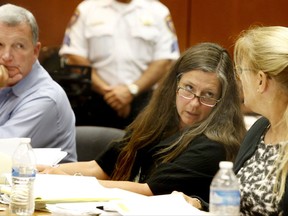 Scott Phillips, left, looks on as his wife Theresa Mullen, center, talk to their attorney Susan Brandt McCrea during the trial on Thursday, Aug. 3, 2017 in Newark.  The parents of Sydney Phillips and her younger sister, Kaitlyn are seeking a court order to allow the girls to return to their Catholic school in Kenilworth after a dispute over one of them wanting to play on the boys basketball team.   (Aristide Economopoulos/NJ Advance Media via AP, Pool)