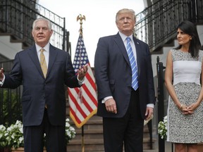 Secretary of State Rex Tillerson, left, speaks following a meeting with President Donald Trump, center, and U.S. Ambassador to the United Nations Nikki Haley, right, at Trump National Golf Club in Bedminster, N.J., Friday, Aug. 11, 2017. (AP Photo/Pablo Martinez Monsivais)