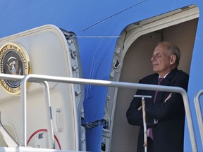 White House Chief of Staff John Kelly stands in the door of Air Force One and watches President Donald Trump, as he arrives in Reno, Nev., Wednesday, Aug. 23, 2017. (AP Photo/Alex Brandon)