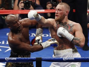 Conor McGregor, right, fights Floyd Mayweather Jr. in a super welterweight boxing match Saturday, Aug. 26, 2017, in Las Vegas. (AP Photo/Eric Jamison)