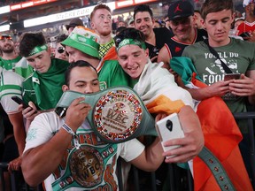 Fans take selfies with the WBC money belt before a weigh-in Friday, Aug. 25, 2017, in Las Vegas. Conor McGregor is scheduled to fight Floyd Mayweather Jr. in a boxing match Saturday in Las Vegas.(AP Photo/John Locher)