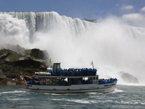 FILE - In this June 11, 2010 file photo, tourists ride the Maid of the Mist tour boat at the base of the American Falls in Niagara Falls, N.Y.   Local lawmakers are asking for a criminal investigation into the discharge of wastewater that turned the water below Niagara Falls black. The Niagara County Legislature passed resolutions Thursday, Aug. 10, 2017  that request investigations by the New York state attorney general, the Niagara County district attorney and the federal Environmental Protection Agency.  (AP Photo/David Duprey, File)