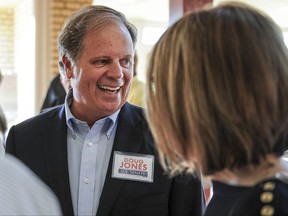 FILE - In this Aug. 3, 2017, file photo, candidate Doug Jones chats with constituents before a Democratic Senate candidate forum at the Princess Theatre in Decatur, Ala.   Jones is facing Michael Hansen , who leads an environmental group, in the Democrat primary on Tuesday, Aug. 15.  .  (Jeronimo Nisa /The Decatur Daily via AP, File)