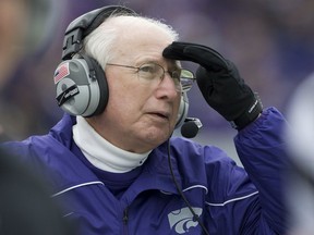 FILE - In this Oct. 6, 2012, file photo, Kansas State coach Bill Snyder watches a replay on the scoreboard during the second half of an NCAA college football game against Kansas, in Manhattan, Kan. Kansas State coach Bill Snyder is back for another season, despite a cancer scare earlier this year. The 77-year-old coach believes he has a team capable of contending for a Big 12 title and even a national championship, and no amount of chemotherapy was going to keep him from leading the Wildcats for the 26th year.  (AP Photo/Orlin Wagner, File)