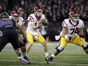 FILE - In this Nov. 12, 2016, file photo, Southern California quarterback Sam Darnold takes a snap during the team's NCAA college football game against Washington in Seattle. USC is in the No. 4 spot in The Associated Press' preseason poll. Darnold, the Heisman Trophy favorite, will be protected by new starting offensive tackles.  (AP Photo/Elaine Thompson, File)