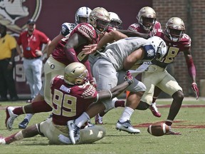 File-This Sept. 10, 2016, file photo shows Florida State's Brian Burns stripping the ball from Charleston Southern's Robert Mitchell in the second half of an NCAA college football game, in Tallahassee, Fla. Florida State's defense returns nine starters to a unit that struggled the first half of last season before rounding into form. Defensive coordinator Charles Kelly is hoping that the lessons the No. 3 Seminoles learned last season pay off. They will find out quickly since the opener is against top-ranked Alabama. (AP Photo/Steve Cannon)