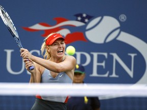 FILE - In this Aug. 27, 2014, file photo, Maria Sharapova, of Russia, returns a shot to Alexandra Dulgheru, of Romania, during the second round of the U.S. Open tennis tournament, in New York. Sharapova has been granted a wild-card invitation for the U.S. Open's main draw. Sharapova is among eight women who were given entry into the 128-player field by the U.S. Tennis Association on Tuesday, Aug. 15, 2017, and by far the most noteworthy. (AP Photo/Jason DeCrow, File)