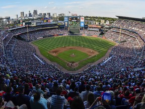FILE - At left, in a May 18, 1996, file photo, Centennial Olympic Stadium is shown during Grand Opening ceremonies in Atlanta. At center, in an Oct. 2, 2016, file photo, fans watch the final baseball game at Turner Field, between the Atlanta Braves and the Detroit Tigers, in Atlanta. At right, in an Aug. 17, 2017, file photo, Georgia State Stadium is shown in Atlanta. From Olympic track and field to major league baseball to, now, college football, this place has undergone plenty of changes since it broke ground less than a quarter-century ago. (AP Photo/File)