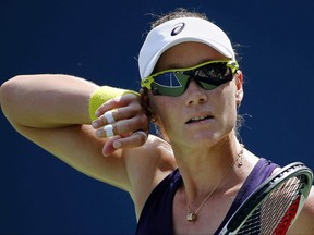 FILE - In this Aug. 26, 2014, file photo, Samantha Stosur, of Australia, wipes sweat from her brow between serves against Lauren Davis, of the United States, during the first round of the 2014 U.S. Open tennis tournament in New York. Stosur, the 2011 U.S. Open champion, has withdrawn from the upcoming U.S Open because of an injured right hand. the U.S. Tennis Association announced, Friday, Aug. 18, 2017. (AP Photo/Elise Amendola, File)