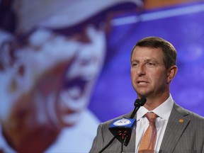 File-This July 13, 2017, file photo shows Clemson head coach Dabo Swinney speaking to the media during the Atlantic Coast Conference NCAA college football media day in Charlotte, N.C.  Swinney is getting a hefty raise after winning the national championship. The university announced Friday, Aug. 25, 2017, its Board of Trustees approved a new 8-year, $54 million contract for Swinney. The deal pays Swinney $6 million this season, has $3.2 million in signing bonuses in three installments and includes a $6 million buyout until the end of 2018. (AP Photo/Chuck Burton, File)