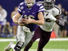 File-This Dec. 28, 2016, file photo shows Kansas State quarterback Jesse Ertz, center, running past Texas A&M linebacker Otaro Alaka (42) during the second half of the Texas Bowl NCAA college football game, in Houston. Ertz is back under center after running for 1,012 yards and 12 touchdowns last season, numbers that made him the Big 12's eighth-leading rusher. (AP Photo/Eric Christian Smith, File)