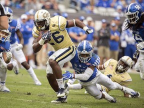 FILE - In this Dec. 31, 2016 file photo, Georgia Tech running back Dedrick Mills (26) is tackled by Kentucky safety Mike Edwards (27) during the second half of the TaxSlayer Bowl NCAA college football game in Jacksonville, Fla. Mills has been kicked off the team for a violation of athletic department rules, the school announced Friday, Aug. 18, 2017.(AP Photo/Stephen B. Morton, File)