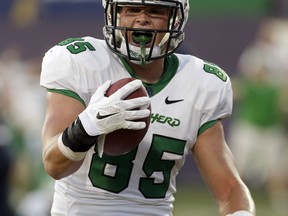 File-This Oct. 18, 2014, shows Marshall tight end Ryan Yurachek scoring a touchdown against Florida International during the first half of an NCAA college football game, in Miami. Good players can get lost on bad teams, but here are a few who will be worth seeking out in 2017. Just don't wait until bowl season because it will probably be too late. (AP Photo/Alan Diaz, File)