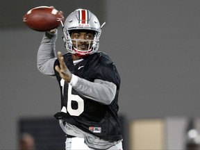 FILE - In this March 7, 2017, file photo, Ohio State quarterback J.T. Barrett runs a drill during an NCAA college football practice in Columbus, Ohio. Barrett is an oddity in modern college football, an elite player who stuck around for five years, a guy who helped win a national championship but still has something to prove. (AP Photo/Jay LaPrete, File)