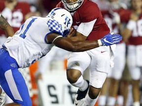 File-This Oct. 1, 2016, file photo shows Alabama quarterback Jalen Hurts (2) being tackled by Kentucky linebacker Courtney Love (51) during the second half of an NCAA college football game in Tuscaloosa, Ala. Love chalks up his promising season anchoring Kentucky's defense to finally getting the chance to regularly play. Now, the senior middle linebacker's goal to help make the Wildcats one of the Southeastern Conference's best defensive units. Love was the Wildcats' third-leading tackler in 2016 with 76 stops, which he believes should have been higher. But it provided an encouraging baseline for the Nebraska transfer, whose leadership has already earned the attention of national award committees.(AP Photo/Butch Dill, File)