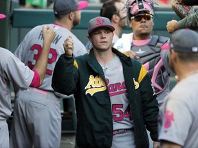 FILE - In this May 13, 2017, file photo, Oakland Athletics starting pitcher Sonny Gray, center, is greeted in the dugout before the team's baseball game against the Texas Rangers, in Arlington, Texas. As the hours tick down to baseball's trade deadline, three standout pitchers remain at the center of attention. Sonny Gray, Justin Verlander and Yu Darvish each have the potential to help a contending team down the stretch, and if any of them are traded Monday, July 31, 2017, it would certainly spice up what has been a fairly pedestrian stretch of deals so far.  (AP Photo/Tony Gutierrez, File)