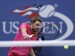 FILE - In this Sept. 11, 2016, file photo, Stan Wawrinka, of Switzerland, returns a shot to Novak Djokovic, of Serbia, during the men's singles final at the U.S. Open tennis tournament, in New York. Defending champion Stan Wawrinka has pulled out of the U.S. Open with an injured knee. Wawrinka announced Friday, Aug. 4, 2017, he would sit out the rest of 2017 because of the knee. (AP Photo/Charles Krupa, File)