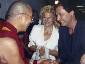 FILE - In this October 1989 file photo, the Dalai Lama, left, talks to the comedy writing and acting team of Renee Taylor and Joe Bologna, during a backstage visit prior to the Dalai Lama's convocation on the subject of compassion at UC Irvine in Irvine, Calif. The Dalai Lama gave a special marriage blessing in the Tibetan Buddhist rite to Taylor and Bologna. Oscar-nominated writer Bologna has died. He was 82. His manager Matt Sherman says Bologna died Sunday, Aug. 13, 2017, after a three-year battle against pancreatic cancer. Taylor credited his doctors for prolonging his life so he could receive a lifetime achievement award at the Night of 100 Stars on Feb. 26. Bologna was nominated for an Oscar in 1971 for best adapted screenplay for "Lovers and Strangers." He won an Emmy in 1973. (AP Photo/File)