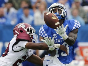 File-THis Sept. 17, 2016, file photo shows Kentucky wide receiver Jeff Badet, right, catching a pass over New Mexico State defensive back Jared Phipps in the first half of an NCAA college football game in Lexington, Ky. For the second straight year, Oklahoma must replace a star receiver. And again, the Sooners feel they have the talent on the roster to get it done. (AP Photo/David Stephenson, File)