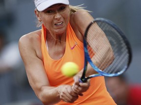 FILE - In this May 8, 2017, file photo, Maria Sharapova hits a return to Eugenie Bouchard, of Canada, during a Madrid Open tennis tournament match in Madrid, Spain. Sharapova played her first WTA match in the United States since 2015 and beat Jennifer Brady 6-1, 4-6, 6-0 on Monday night, July 31, 2017, in the opening round of the Bank of the West Classic. (AP Photo/Francisco Seco, File)