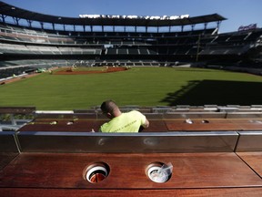 FILE - In this March 9, 2017, file photo, cup holders designed to keep drinks cold line an outfield viewing section at SunTrust Park, the Atlanta Braves' new baseball stadium, in Atlanta. On hot days fans can take advantage of the refrigerated drinker coolers that are one of the new additions at SunTrust Park. (AP Photo/David Goldman, File)
