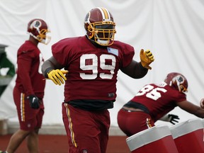 FILE - In this May 24, 2017, file photo, Washington Redskins defensive lineman Phil Taylor Sr., works during practice at the team's NFL football training facility at Redskins Park, in Ashburn, Va. Urged by his wife to continue playing, Taylor is a good bet to make the Washington Redskins' roster as long as he continues to show the same play that made him a first-round pick of the Cleveland Browns in 2011. (AP Photo/Alex Brandon, File)