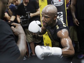 File- This Aug. 10, 2017, file photo shows Floyd Mayweather Jr. training at his gym in Las Vegas. Look at any boxing website, and the comments will largely all be the same. Mayweather Jr.'s fight with Conor McGregor is a joke, a spectacle that has little to do with real boxing. No reason to spend two cents on it, much less $100, when there's a real super fight coming up a few weeks later between Gennady Golovkin and Canelo Alvarez. (AP Photo/John Locher, File)
