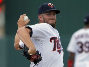 FILE - In this March 23, 2016, file photo, Minnesota Twins' Glen Perkins throws a warm up pitch in the seventh inning of a spring training baseball game against the Tampa Bay Rays, in Fort Myers, Fla. The Minnesota Twins have reinstated relief pitcher Glen Perkins from the disabled list, where he's been for more than 16 months because of shoulder trouble. The Twins made the move Thursday, Aug. 17, 2017, before their doubleheader against Cleveland, with all arms needed on deck against the division leaders. (AP Photo/Tony Gutierrez, File)