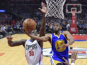 FILE - In this Feb. 2, 2017, file photo, Golden State Warriors guard Ian Clark, right, shoots as Los Angeles Clippers forward Brandon Bass defends during the first half of an NBA basketball game, in Los Angeles. A person familiar with the situation says former Golden State Warriors guard Ian Clark has agreed to play for the New Orleans Pelicans on a one-year, veteran minimum contract. The person spoke to The Associated Press on condition of anonymity Wednesday morning, Aug. 2, 2017, because the signing was not yet official. (AP Photo/Mark J. Terrill, File)