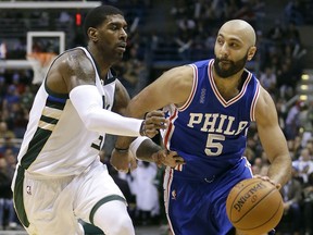 FILE - In this Wednesday, Dec. 25, 2015 file photo, Philadelphia 76ers' Kendall Marshall (5) drives against Milwaukee Bucks' O.J. Mayo during an NBA basketball game in Milwaukee. The jerseys say USA, though that's about all that will be recognizable.  The Americans are cautiously entering a whole new basketball world, one in which not only are the best U.S. players not available, but neither are any in the NBA. LeBron James, Kevin Durant and the stars might show up in a few years for the Basketball World Cup and Olympics, but only if a group of minor leaguers can get them there. (AP Photo/Aaron Gash, File)