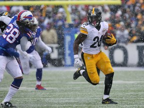FILE - In this Dec. 11, 2016, file photo, Pittsburgh Steelers running back Le'Veon Bell (26) carries against the Buffalo Bills during the second half of an NFL football game in Orchard Park, N.Y. Bell has suggested on Twitter that he will return to the team on Sept. 1, the day after Pittsburgh's final preseason game. Bell hasn't signed his franchise tender and has been holding out through training camp. Responding to a fan Tuesday night, Aug. 22, asking when he plans to end his holdout, Bell wrote "9-1-17" and added a wink. (AP Photo/Bill Wippert, File)