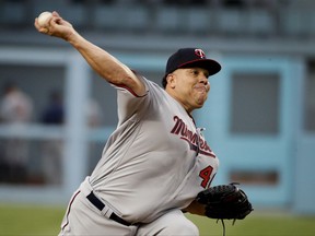 FILE - In this July 24, 2017, file photo, Minnesota Twins starting pitcher Bartolo Colon throws against the Los Angeles Dodgers during the first inning of a baseball game in Los Angeles. Colon, 44, is the oldest active player in the majors. But with a 2-8 record and 8.14 ERA through the All-Star break, maybe not for long. (AP Photo/Jae C. Hong, File)