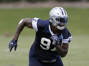 FILE - In this June 13, 2017, file photo, Dallas Cowboys defensive end Taco Charlton rushes from the line of scrimmage during an NFL football practice at the team's training facility, in Frisco, Texas. Charles Tapper can't help but think of himself as another rookie alongside first-round pick Taco Charlton, also a pass rusher, even though the former Oklahoma player has been in the NFL a year longer. He didn't play a down in 2016, preseason included, before joining Charlton in the Hall of Fame game last week.(AP Photo/Tony Gutierrez, File)