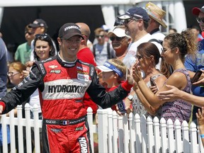 FILE - In this Sunday, July 31, 2016 file photo, Sebastien Bourdais, of France, greets fans during driver introductions for the IndyCar Honda Indy 200 auto race at Mid-Ohio Sports Car Course in Lexington, Ohio.  Sebastien Bourdais will return to IndyCar competition this weekend after a three-month recovery from an accident at Indianapolis Motor Speedway, Wednesday, Aug. 23, 2017. The Frenchman fractured his pelvis and right hip during a crash while qualifying for the Indianapolis 500. A return this season seemed to be a stretch, but Bourdais vowed to race in next month's season finale. (AP Photo/Tom E. Puskar, File)