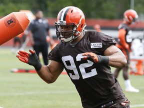 FILE - In this June 6, 2017, file photo, Cleveland Browns defensive end Desmond Bryant (92) runs a drill at the NFL football training facility, in Berea, Ohio. Bryant couldn't do anything to help the Browns last season after suffering a serious injury. Now that he's back on the field, the defensive end is relishing every moment because he knows how quickly it can all be taken away. (AP Photo/Ron Schwane, File)