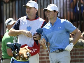 FILE - In this Aug. 28, 2016 photo, Rory McIlroy of Northern Ireland, right, and his caddy, J. P. Fitzgerald, look down the fairway before McIlroy tees off from the first hole during the final round of The Barclays golf tournament in Farmingdale, N.Y. McIlroy parted ways with J.P. Fitzgerald after the British Open and will use his best friend, Harry Diamond, as his caddie in the Bridgestone Invitational and the PGA Championship next week. (AP Photo/Kathy Kmonicek), file