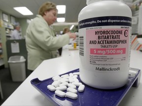 FILE - This Tuesday, Feb. 19, 2013 file photo shows hydrocodone pills, also known as Vicodin, arranged for a photo at a pharmacy in Montpelier, Vt. Leftover opioids are a common dilemma for surgery patients; a study published Wednesday, Aug. 2, 2017, suggests that after several common operations most don't use all their pills and many store the remainders unsafely at home. (AP Photo/Toby Talbot)