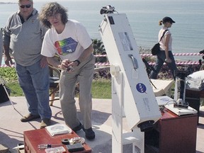 This 2006 photo provided by Glenn Schneider shows him with his "lug-o-scope" in Turkey. Schneider, was 14 in 1970 when he saw his first eclipse. "I was frozen in place," he recalled. "I had binoculars around my neck for two and a half minutes and I never picked them up." Now a University of Arizona astronomy professor, Schneider said when it was over "I was shaking. I was crying. I was overwhelmed. It was at that instant when I said 'Yeah, this is what I'm going to do with the rest of my life'." (Courtesy Glenn Schneider via AP)