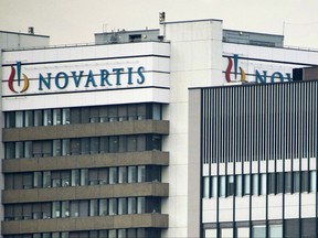 FILE - This Oct. 25, 2011 file photo shows the logo of Swiss pharmaceutical company Novartis AG on one of their buildings in Basel, Switzerland. According to results published Sunday, Aug. 27, 2017, for the first time, a drug has helped prevent heart attacks by curbing inflammation, a new and very different approach than lowering cholesterol, which has been the main focus for decades. Canakinumab's maker, Novartis, sponsored the study. (Georgios Kefalas/Keystone via AP, File)
