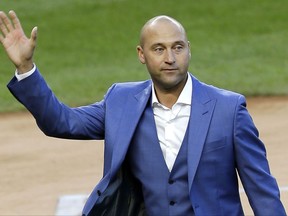 FILE - In this May 14, 2017, file photo, former New York Yankees player Derek Jeter waves to fans during a ceremony retiring his number at Yankee Stadium in New York. A person familiar with the negotiations says the Miami Marlins have told Major League Baseball they intend to sign an agreement to sell the team to a group that includes Jeter. The person confirmed the Marlins' plans to The Associated Press on condition of anonymity Friday, Aug. 11, 2017, because the team had not commented publicly. (AP Photo/Seth Wenig, File)