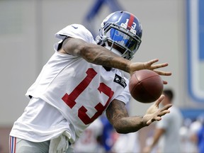 FILE - In this Aug. 8, 2017, file photo, New York Giants wide receiver Odell Beckham works out during NFL football training camp, in East Rutherford, N.J. After a miserable end to the 2016 season and the brouhaha about his desire to be the NFL's highest paid player, Beckham is having a great time at training camp with the Giants. (AP Photo/Julio Cortez, File)