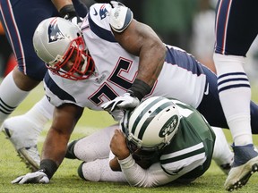 FILE - In this Dec. 21, 2014, file photo, New England Patriots defensive tackle Vince Wilfork (75) tackles New York Jets' Geno Smith (7) during the first half of an NFL football game in East Rutherford, N.J. Former New England and Houston player Wilfork announced his NFL retirement Monday, Aug. 7, 2017, in a barbecue commercial, a fitting farewell for a big guy who loved to eat. (AP Photo/Julio Cortez, File)