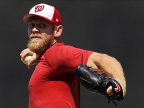 FILE - In this Aug. 9, 2017, file photo, Washington Nationals pitcher Stephen Strasburg throws from the mound during a simulated baseball game, at Nationals Park in Washington. Strasburg has been on the disabled list with a nerve impingement in his right elbow since July 27, 2017. (AP Photo/Carolyn Kaster, File)