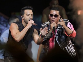 FILE - This April 27, 2017, file photo shows singers Luis Fonsi, left, and Daddy Yankee during the Latin Billboard Awards in Coral Gables, Fla. An MTV spokesperson said in a statement to The Associated Press on Monday, Aug. 14, 2017, that the 'Despacito' video was not submitted for consideration for nomination at the 2017 Video Music Awards. The hit song's video has not aired on MTV or MTV2, but is being played on MTV Tres, the company's Latin channel. Universal Music Latin Entertainment, the label that released Luis Fonsi and Daddy Yankee's "Despacito," said they welcome MTV to play Spanish videos on its main channel in a statement to the AP. (AP Photo/Lynne Sladky, File)