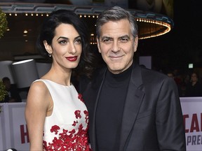 FILE - In this Feb. 1, 2016, file photo, Amal Clooney, left, and George Clooney arrive at the world premiere of "Hail, Caesar!" in Los Angeles. The couple announced Tuesday, Aug. 22, 2017, that their Clooney Foundation for Justice is supporting the Southern Poverty Law Center with a $1 million grant to combat hate groups in the United States. (Photo by Jordan Strauss/Invision/AP, File)